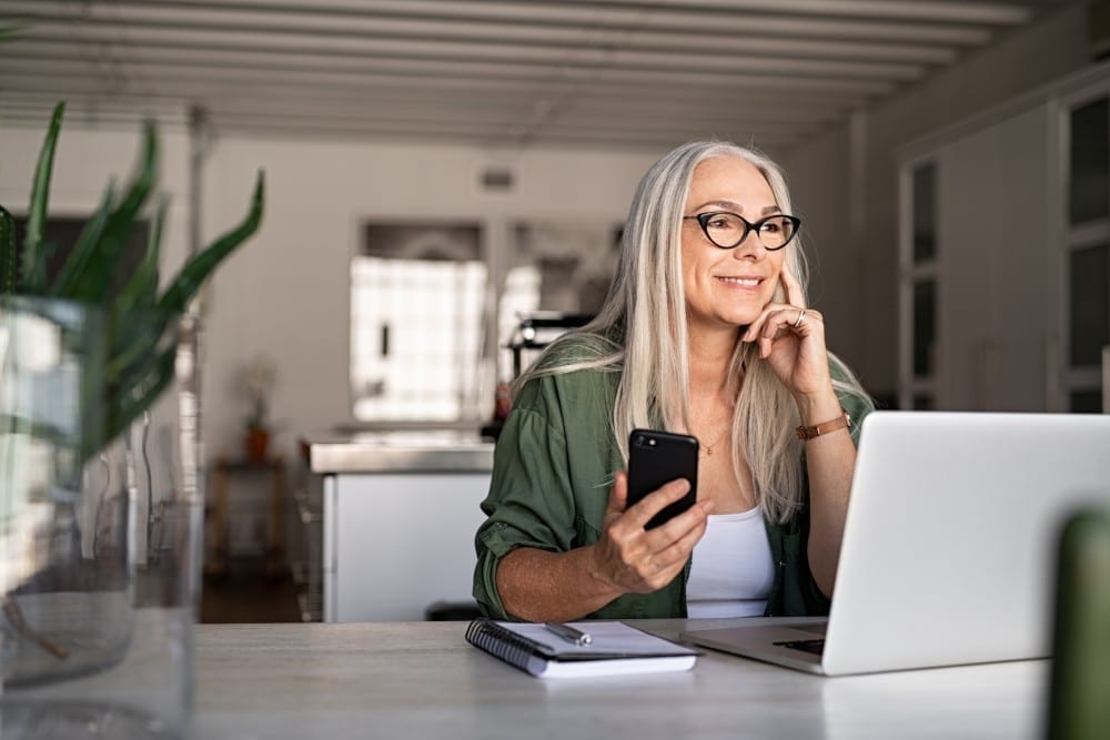 Retirement-NEW Senior sitting in front of computer on the phone