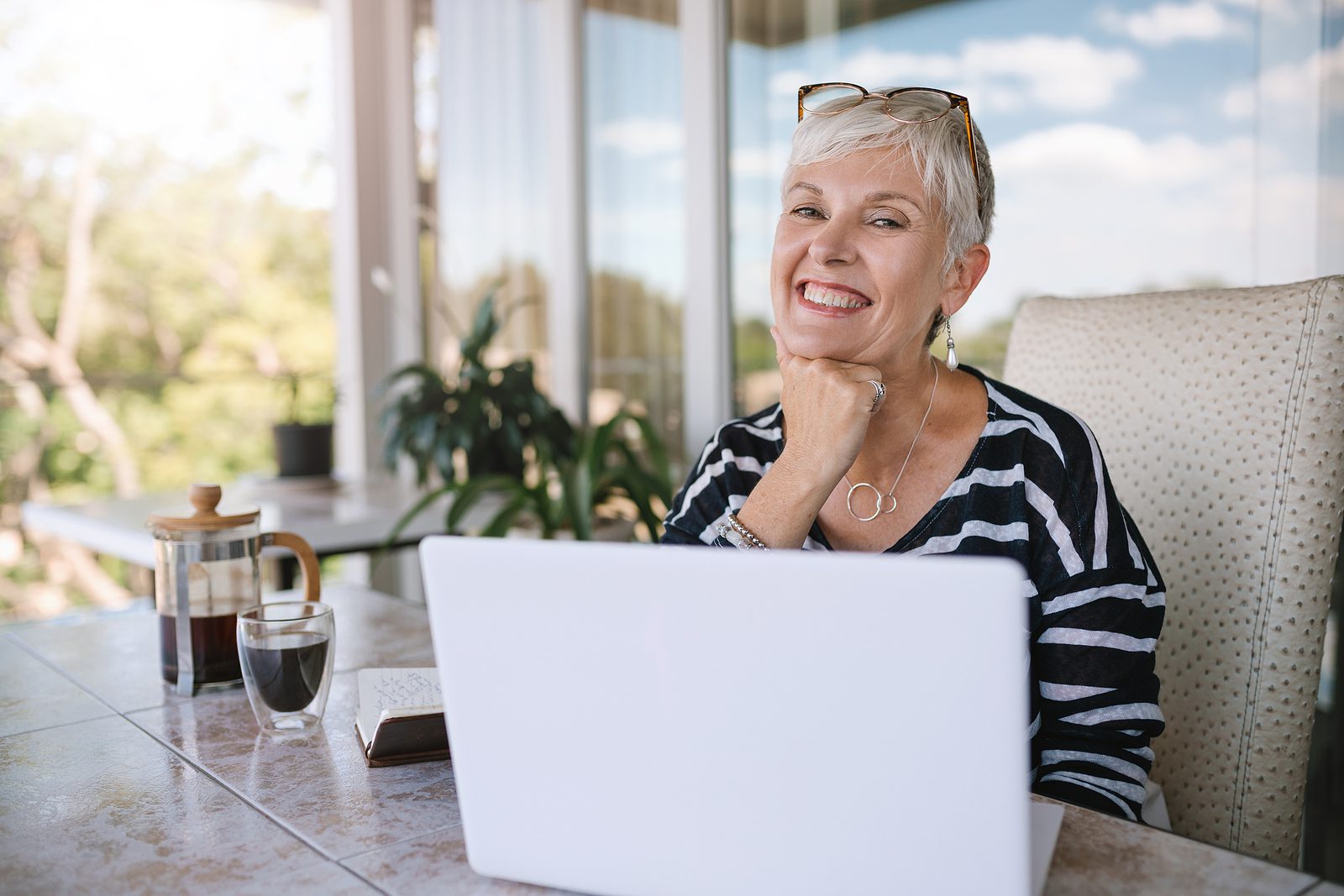 Woman using a computer on a balcony